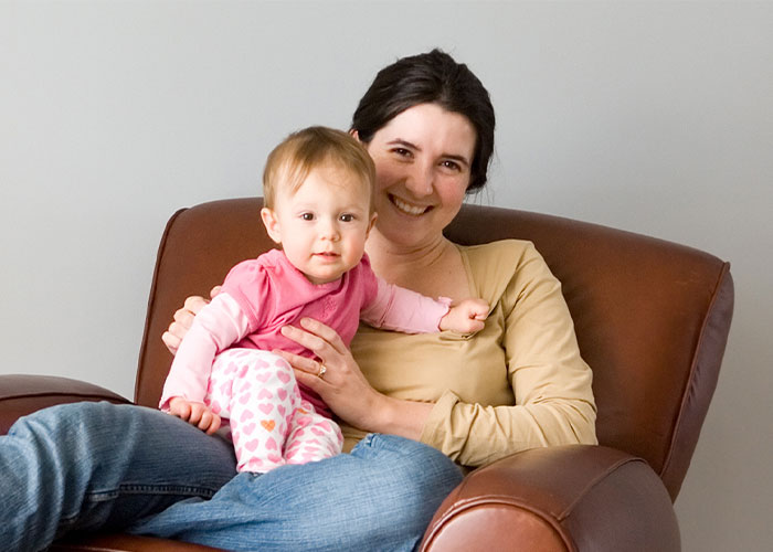 mother sitting in chair with baby